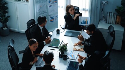 Obraz premium Top view of professional executive manager show increasing sales chart to diverse team while group of diverse business people listening and clapping hands to celebrate successful project. Directorate.