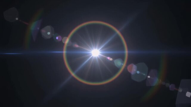 Shimmering radiant lens flare starburst ring on dark background.
