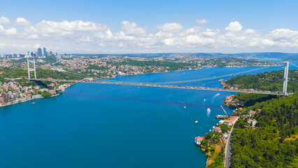 Fototapeta premium Istanbul, Turkey. Fatih Sultan Mehmet Bridge is a suspension bridge across the Bosphorus Strait, between Europe and Asia. Sunny day, Aerial View