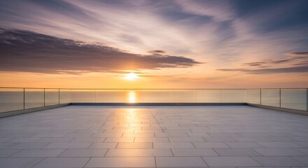 Fototapeta premium Modern balcony overlooking a serene ocean sunset with dramatic clouds reflecting golden light on the water and tiled floor