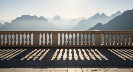 Fototapeta premium Balcony view of misty mountains at sunrise with dramatic shadows on the terrace, serene landscape panorama