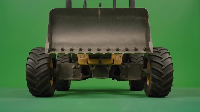 Wheel loader bucket lifting sequence on greenscreen background.