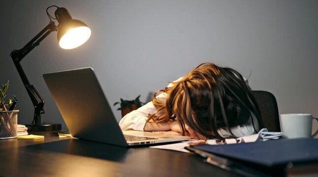 Tired woman falling asleep on laptop at night desk, close up slow motion burnout video for advertisement
