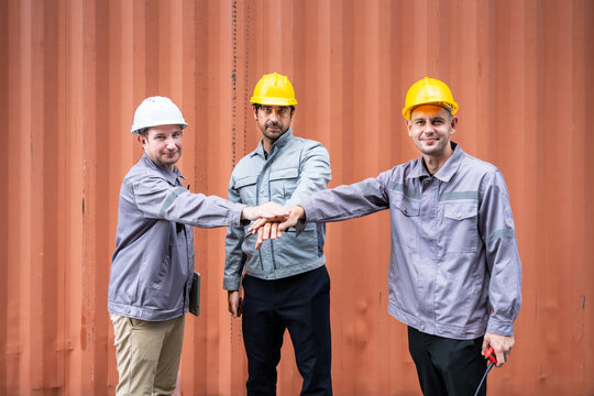 Engineer industrial workers males teamwork hands together at shipping container logistics site