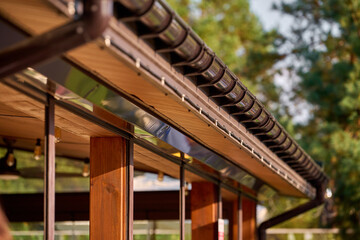 Part of the building cornice and drainage system of the building. semicircular gutter with a drainpipe. © Andrey