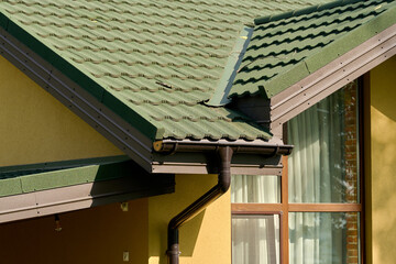 Part of the building cornice and drainage system of the building. semicircular gutter with a drainpipe. © Andrey