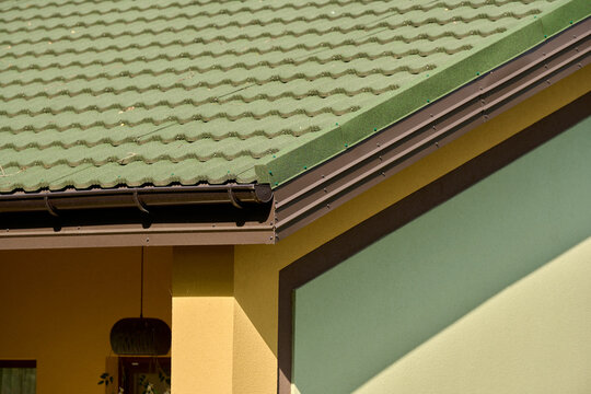 Roof line with brown gutters and wood soffit