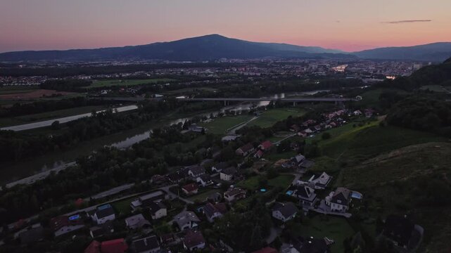 Gorca - Marijina cerkev v Malečniku , Slovenia - drone view on the church, river Drava and Maribor during sunset