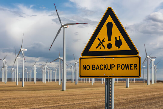 Wind Turbine Farm with Warning Sign Pointing to Energy Reliability and No Backup Power Concept