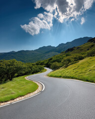 Obraz premium Curved asphalt road mountain green grass blue sky sunlight scenic outdoor summer nature peaceful landscape