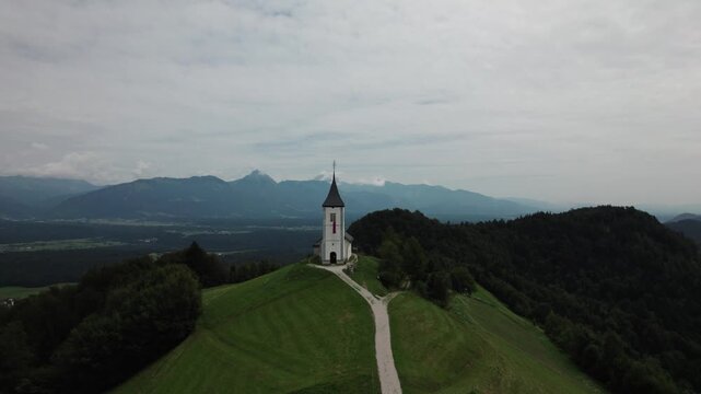 Katoli&scaron;ka cerkev Svetega Primoža in Felicijana- epic church in Slovenian mountains on a hill, drone footage