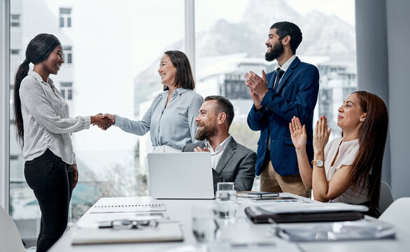 Woman, team and handshake with applause for celebration at promotion with smile at insurance company. Business people, shaking hands and success for deal, meeting and happy at risk management agency