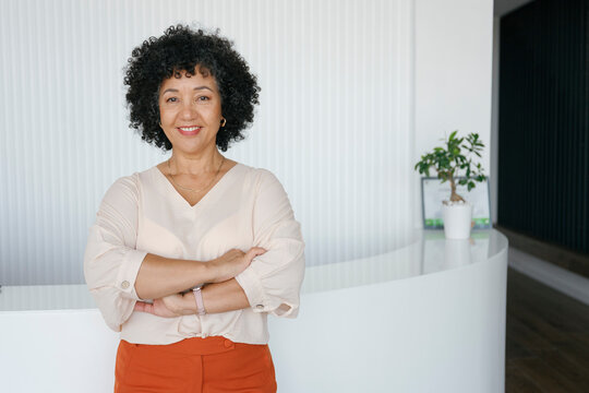 Confident businesswoman smiling in modern office portrait