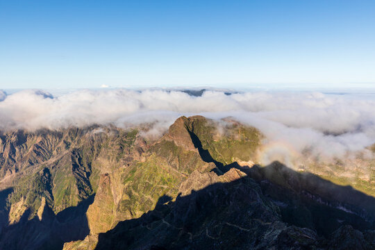 Rainbow halo and clouds over Pico Ruivo mountain Madeira Portugal
