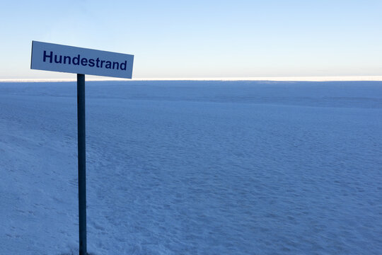 Frozen Baltic Sea and Hundestrand sign in winter at R�gen Baabe