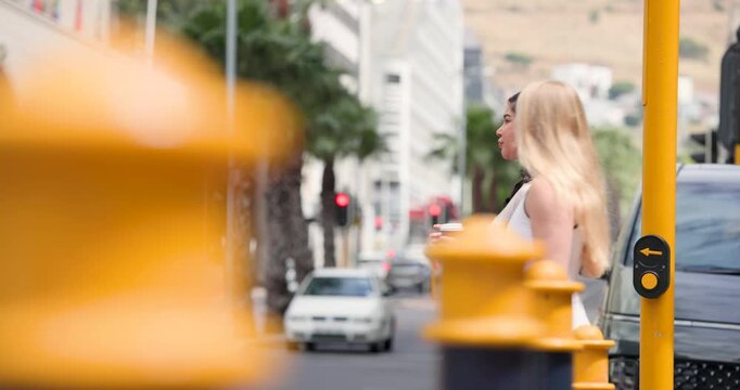 Three pedestrians at curb with coffee preparing to cross as signal turning green, copy space
