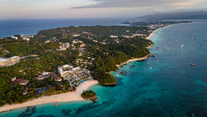 Obraz premium drone above Boracay at White Beach, vibrant turquoise ocean and white sandy shoreline lined with palm trees and resorts, Philippines travel holiday