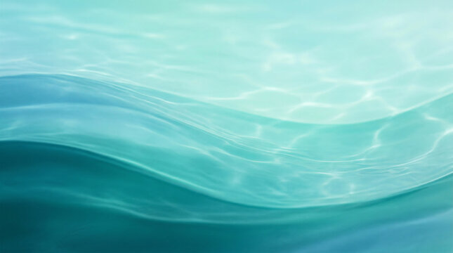 Ocean waves create an abstract summer background with layers of blue and green colors reflecting sunlight