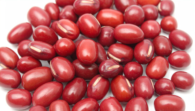 Pile of vibrant red adzuki beans with distinct white hilum on a clean white background
