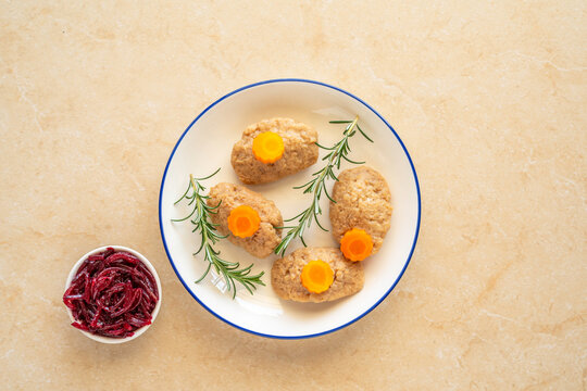 Food background with gefilte fish and bitter herbs maror for Jewish holiday Pesach or Passover.
