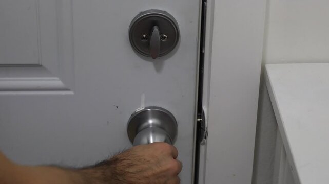Close-up of a deadbolt lock turned horizontally, indicating that the door is unlocked and ready to open.