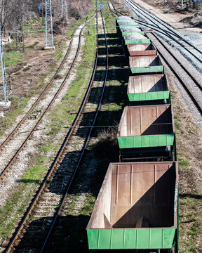 Freight train wagons on parallel railway tracks showing cargo transport, rail infrastructure and industrial logistics network.