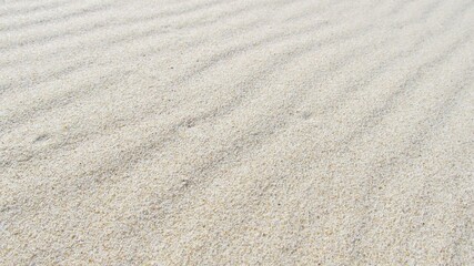 Texture de sable blanc fin avec des ondulations naturelles créées par le vent. © Lazok27