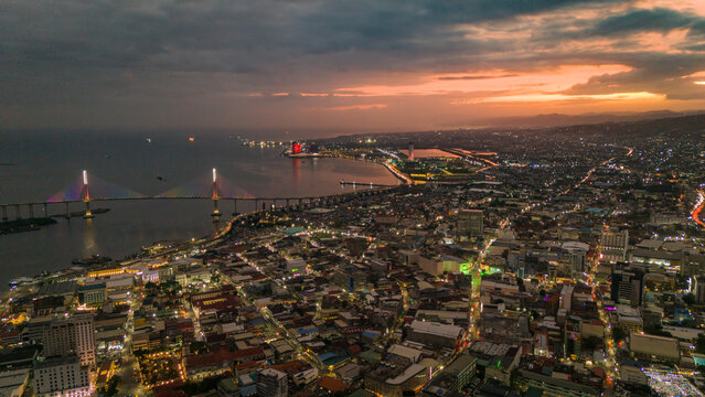 Sunset drone aerial skyline cityscape view of Cebu City Philippines island golden hours light