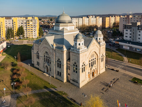 Aerial view of the grand synagogue, its dome gleaming against the backdrop of residential buildings, a testament to history and resilience, Lucenec, Banska Bystrica Region, Slovakia.