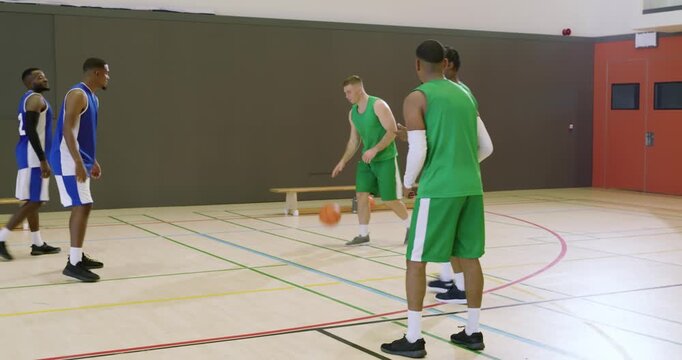 Man retrieving ball from sideline dribbling, shooting to score over hoop