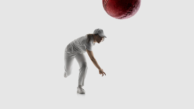 Female cricket player bowling ball action shot isolated on white background. Concept of sports betting visuals, match promo content, sports ads usage, athlete branding, performance showcase.