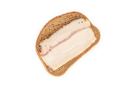Food background with slice of fat tail fat on dark bread.