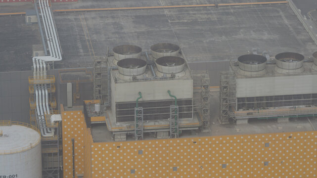 Aerial view of the industrial complex, a symphony of pipes and cooling towers against a backdrop of concrete, Changhua, Changhua County, Taiwan.