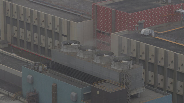 Aerial view of the stark geometric architecture and cooling towers release pale plumes into the sky, Google datacenter Taiwan, Changhua County, Taiwan.