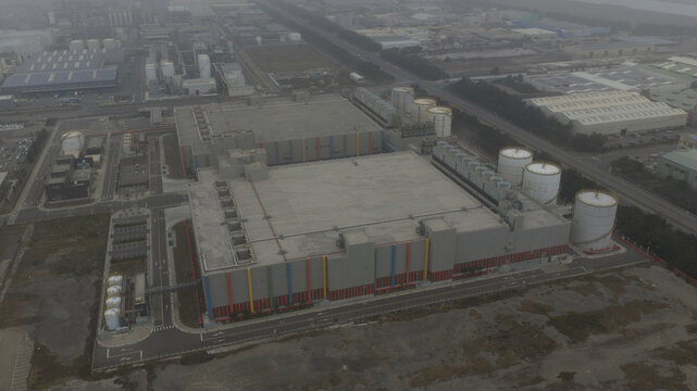 Aerial view of the Google datacenter, a modern industrial landscape with geometric buildings and cylindrical tanks under a muted sky, Changhua, Changhua County, Taiwan.