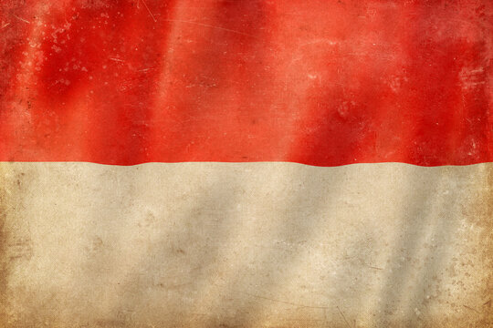 Old vintage flag of Monaco, worn and stained