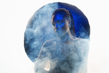 Portrait of authentic young african girl in blue neon light smog in the studio