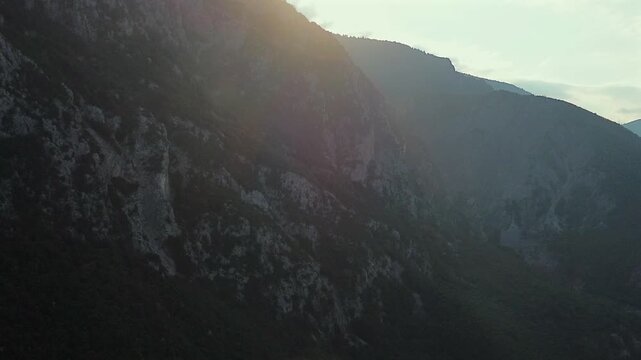 Cinematic drone shot of the rugged cliffs at Thermopylae, Greece. Atmospheric sunlight over the historic mountain pass where the famous battle took place. Ideal for history and travel documentaries.
