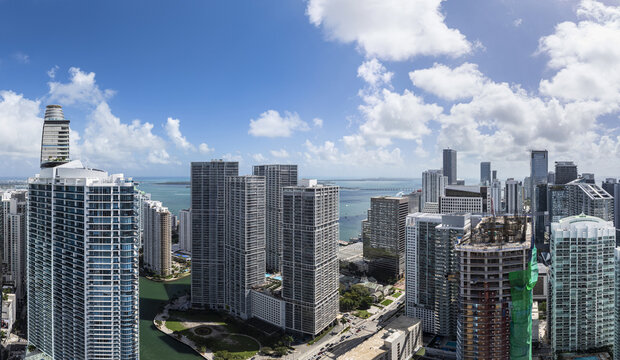 Aerial view of towering skyscrapers reach for the sky, reflecting the azure waters of Biscayne Bay, Brickell, Miami, Florida, United States.
