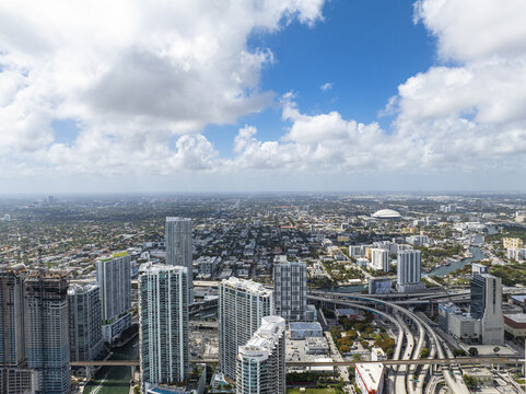 Aerial view of gleaming skyscrapers pierce the skyline, a symphony of steel and glass reflecting the vibrant hues of the sky, Brickell, Miami, Florida, United States.