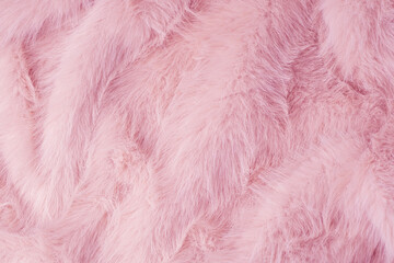 Fototapeta premium Soft pink fluffy fabric textile background with beautiful textured waves and delicate pattern