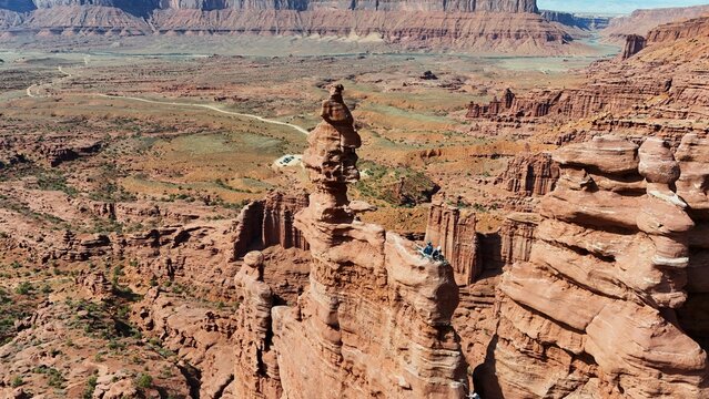 Aerial view of a striking desert landscape, where red rock formations meet the distant mesas in a symphony of earthy tones, Moab, Utah, United States.