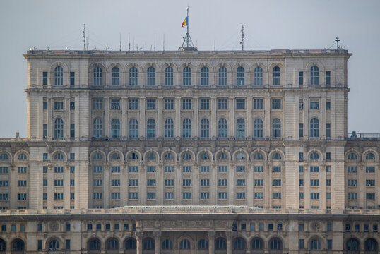 Aerial view of the Palace of the Parliament stands in stark contrast to the sky above, its symmetrical facade a testament to architectural grandeur, Bucuresti, Bucuresti, Romania.