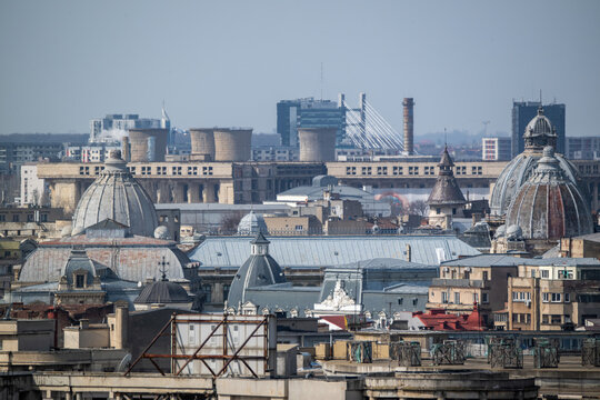 Aerial view of the city showcasing a blend of modern and historical buildings, including the iconic domes and industrial structures, Bucharest, Bucharest, Romania.
