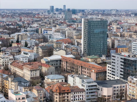 Aerial view of the skyline, with its mix of modern glass towers and historic buildings under a pale sky, Bucharest, Bucharest, Romania.
