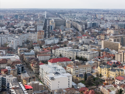 Aerial view of a sprawling cityscape with buildings, streets, and a long boulevard stretching towards the horizon, Bucharest, Bucharest, Romania.