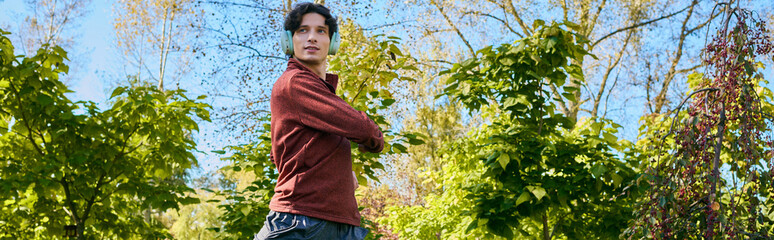 Naklejka premium Young man in stylish sport jacket enjoys a vibrant spring day outdoors