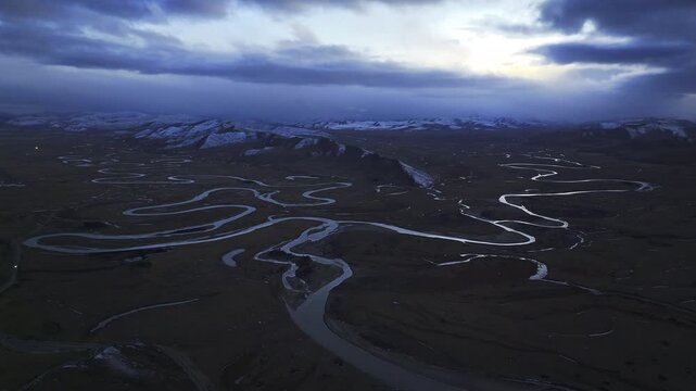 Aerial panoramic view of Manzetang Wetland Nature Reserve at twilight: The winding Jiaqu River under the blue hour on the Zoige Plateau