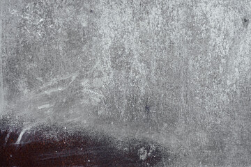 Obraz premium Rough gray stone surface with dark brown stain and white streaks.