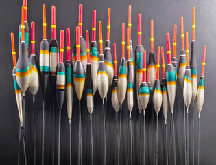 Fishing floats arranged in a display showing various colors and shapes at a market during daylight hours in a simple setting © OlegDoroshin